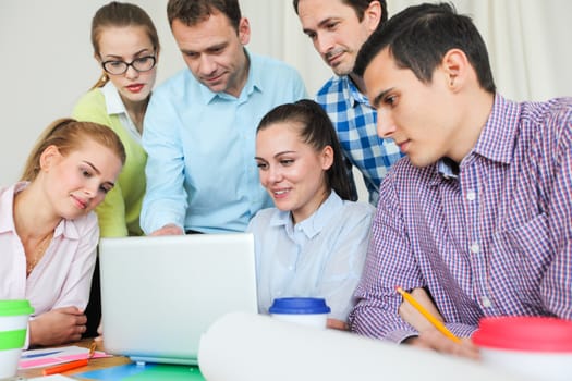 Business team work together looking at one laptop at workplace