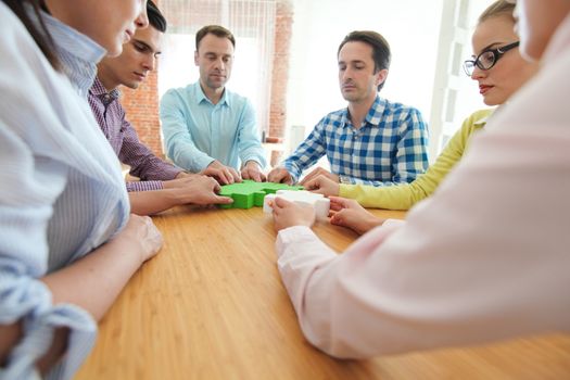 Hipster business successful teamwork concept, business people group assembling jigsaw puzzle