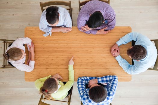 Hipster business teamwork brainstorming planning meeting concept, people team sitting around the table pointing to copy space