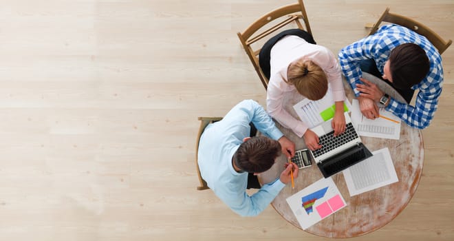 Business team meeting, people in casual clothes working with financial statistics at office desk