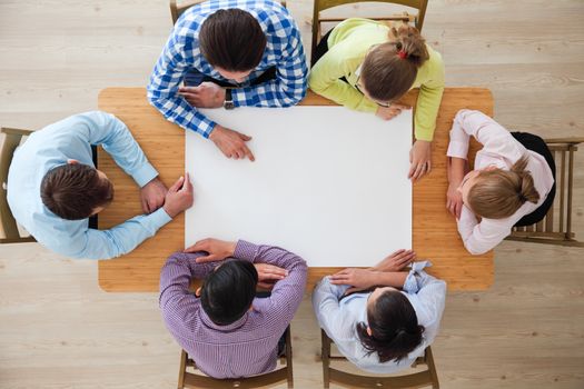Hipster business teamwork brainstorming planning meeting concept, people team sitting around the table with white paper and pointing, copy space