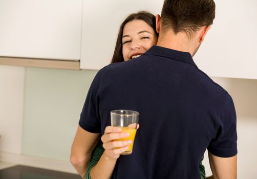 Embraced young couple on the kitchen 