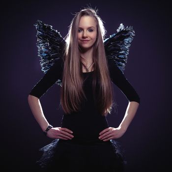 cute slim girl in dark angel costume