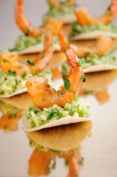   light snack of crisps with avocado filling and fried shrimp flavored with herbs.