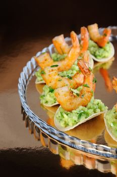   light snack of crisps with avocado filling and fried shrimp flavored with herbs.