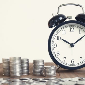 Stack Of Coins With Black Fashioned Alarm Clock For Display Planning Money Financial And Business Accounting Concept, Time Is Money Concept, Time To Work At Make Money, Vintage Color Tone