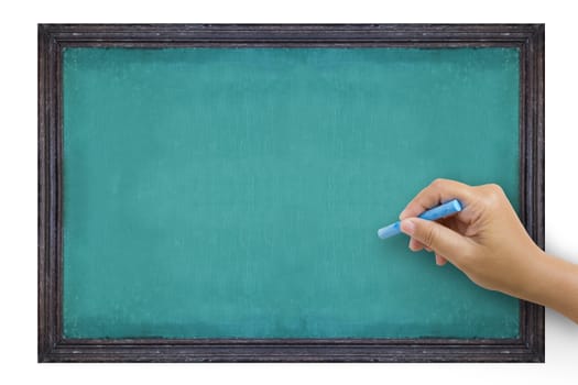 The hand that catches Chalk is preparing to write the alphabet on empty green chalkboard with black wooden frame isolated on white background, vintage wall texture background. 