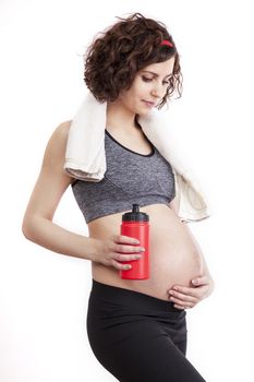 Young pregnant woman practicing fitness. Isolated on white background