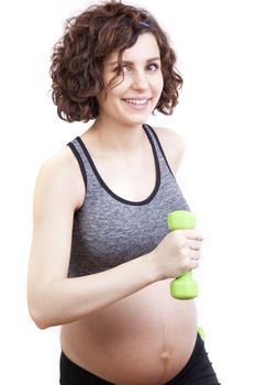 Young pregnant woman practicing fitness. Isolated on white background