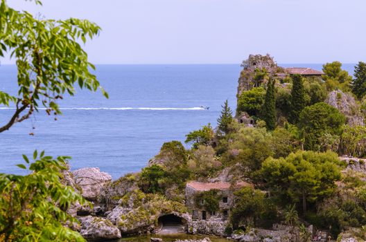 View of island and Isola Bella and blue ocean water in Taormina, Sicily, Italy