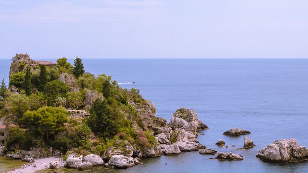 View of island and Isola Bella and blue ocean water in Taormina, Sicily, Italy