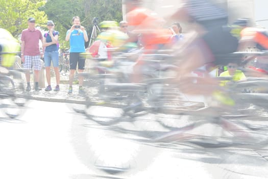 Abstract arty background : motion blur of bicycle racers competing on city streets. Tour of cycling. Blurry background sport with cyclists.