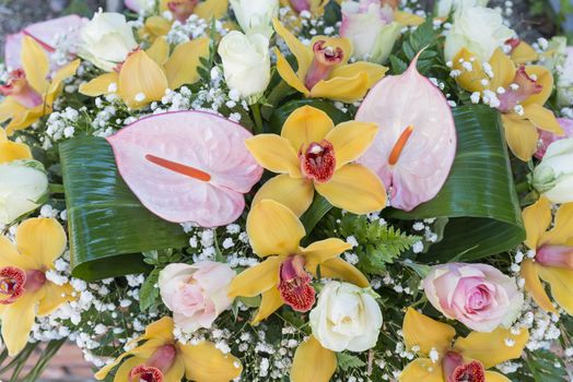 bouquet with flowers as lily in white yellow and with green leaves