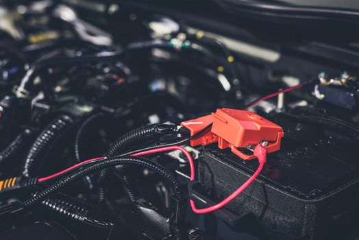 Clese up battery charging cables transferring power to a dead battery