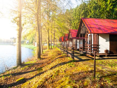 Small wooden forest cottages at the water.