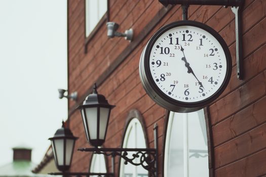 Urban historical architecture with vintage clock in street in London.