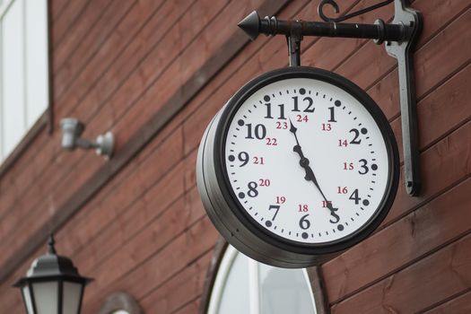 Urban historical architecture with vintage clock in street in London.