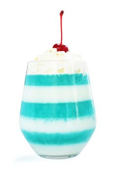 Blue striped jello dessert in glass with whipped cream and red candied cherry on top isolated on white background