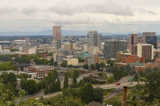 Portland Oregon downtown cityscape scenic view by freeway nestled among trees