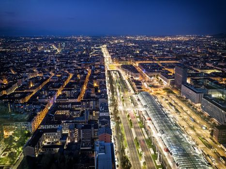 From above panoramic view of Turin city burning with lights in night time, Italy.