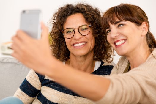 Two beautiful firends at home making  a selfie