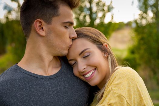 Portrait of a young beautiful couple hugged together