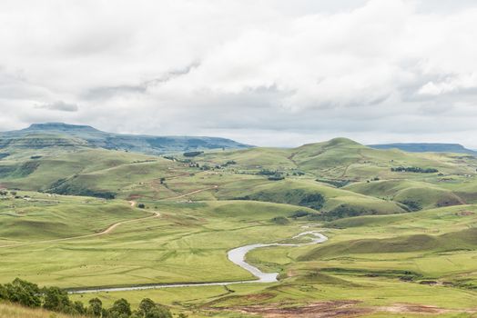 A farm landscape with the Mlambonja River near Cathedral Peak in the Kwazulu-Natal Drakensberg