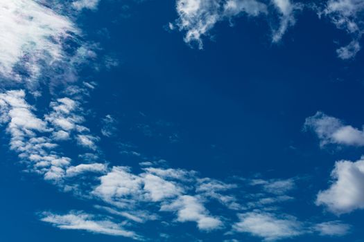 Deep blue bright sky with clouds background