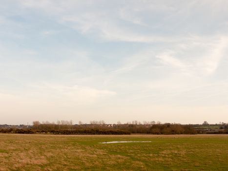 large open farm field empty grass grassland spring sky; essex; england; uk