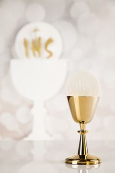 Holy communion a golden chalice, composition isolated on white