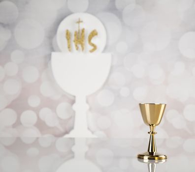 Holy communion a golden chalice, composition isolated on white