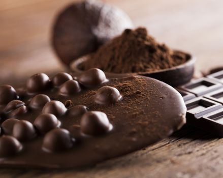 Aromatic cocoa and chocolate on wooden background