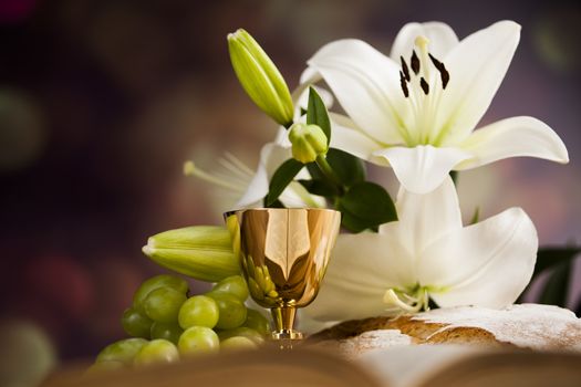 Holy communion a golden chalice with grapes and bread wafers