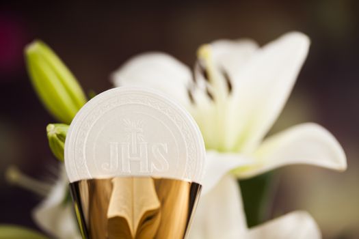 Holy communion a golden chalice with grapes and bread wafers