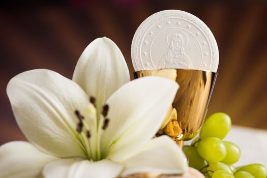 Holy communion a golden chalice with grapes and bread wafers