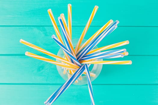 Colorful cocktail tubes in a glass cup