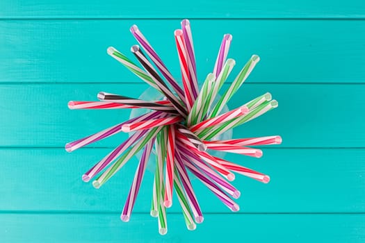 Colorful cocktail tubes in a glass cup