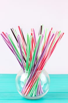 Colorful cocktail tubes in a glass cup