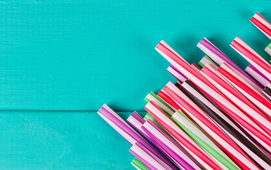 Drinking straws for party on blue pastel background with copy space. Top view