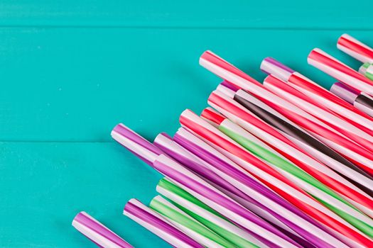 Drinking straws for party on blue pastel background with copy space. Top view