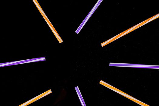 cocktail colorful plastic tube on a black background