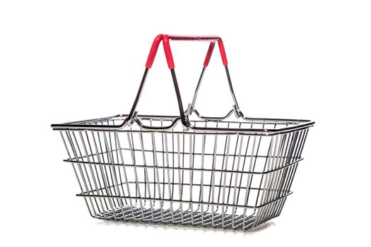 tiny metal shopping basket against white background