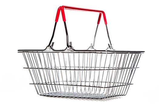 tiny metal shopping basket against white background