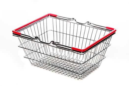 tiny metal shopping basket against white background