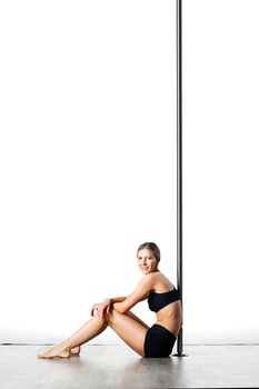 tired pole dance girl sitting and resting against white background