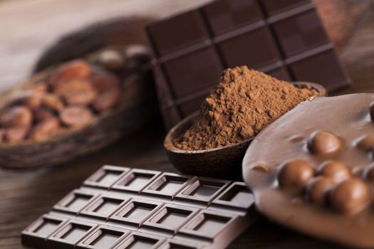 Aromatic cocoa and chocolate on wooden background