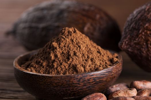 Aromatic cocoa and chocolate on wooden background