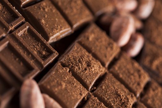 Aromatic cocoa and chocolate on wooden background