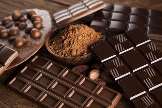 Aromatic cocoa and chocolate on wooden background