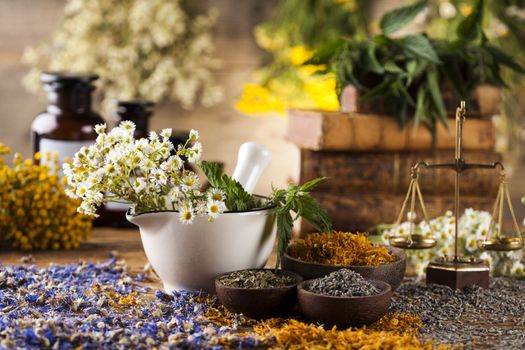 Herbs medicine,Natural remedy and mortar on vintage wooden desk background